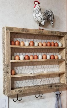 a chicken on top of a shelf with eggs in it