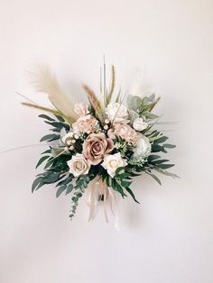 a bouquet of flowers is hanging on the wall