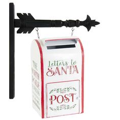 a mailbox with an arrow on the front hanging from a chain that says letters to santa