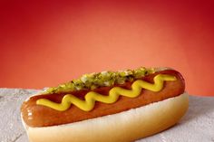 a hot dog with mustard and relish on it