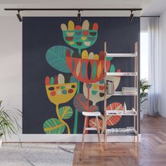 a wall mural with flowers on it in an empty room next to a ladder and potted plant