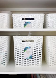 three white plastic baskets sitting on top of a shelf next to each other in a closet