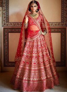 a woman in a red and gold bridal gown