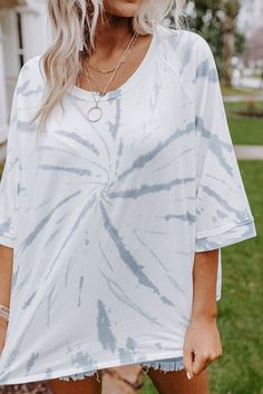 Sparks are sure to fly when you complete your look with this casual white top featuring lightweight material patterned with light blue tie dye, a rounded neckline, short sleeves, and a relaxed silhouette that ends in a straight hemline!  on products  Measurements S variant has  a Bust of 62",  a Hip of 63",  a Length of 24",  a Sleeve Length of 16",  a Waist of 62".  M variant has  a Bust of 64",  a Hip of 65",  a Length of 24",  a Sleeve Length of 16.5",  a Waist of 64".  L variant has  a Bust Casual Tie Dye Tops For Day Out, White Soft-washed Top For Vacation, White Soft-washed Vacation Top, Soft-washed White Vacation Top, Cotton Tie Dye Tops For A Day Out, Casual Short Sleeve Bleached Tops, Casual Bleached Short Sleeve Top, Tie Dye Short Sleeve Vacation Top, Tie Dye Short Sleeve Top For Vacation