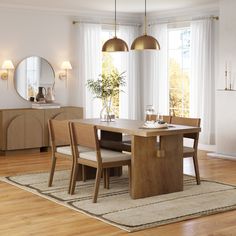 a dining room table with four chairs and a mirror on the wall above it, in front of a large window