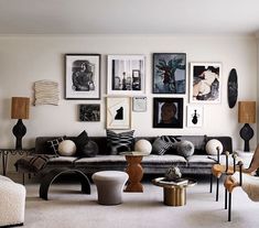 a living room filled with lots of furniture and pictures on the wall above it's couch