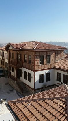 an aerial view of two buildings with brown roof tiles