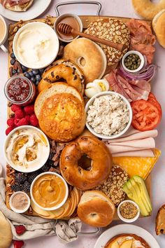 an assortment of breads, pastries and dips on a platter with various toppings