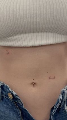 a woman's stomach with the word love written in small letters on her belly