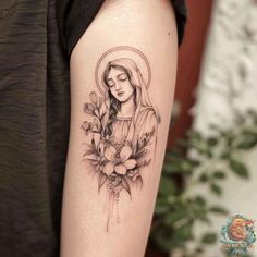 a woman's arm with a tattoo on it and flowers in the middle of her arm