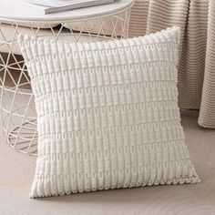 a white pillow sitting on top of a table