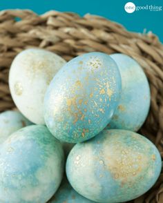 some blue and white eggs in a basket