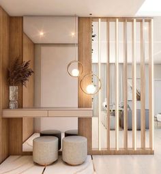 a living room with two stools and a table in front of a wooden wall