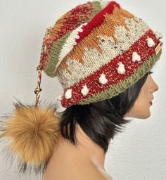 a knitted hat with pom - pom attached to the top of it