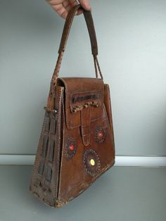 Vintage Bag Of Genuine Calfskin - Retro leather bag - Old leather bag from 70' - brown leather bag - Genuine Leather handbag - Shoulder bag Women shoulder bag made of genuine leather . In good vintage condition . Dimensions: Height without the handle - 26 cm Bottom width - 24.5 cm Depth - 4 cm For other similar items please check here : https://www.etsy.com/shop/TheVINTAGEShopBG?ref=seller-platform-mcnav&section_id=22456024 All pictures are real . You buy exactly what you see in the photos . Handmade Retro Brown Bag, Retro Vintage Brown Leather Bags, Handmade Retro Brown Bags, Vintage Brown Satchel Bag, Brown Satchel Box Bag With Handles, Brown Leather Handheld Shoulder Bag, Vintage Brown Rectangular Shoulder Bag, Vintage Leather Bag, Rectangular Shape, Vintage Leather Rectangular Bag