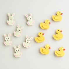 several rubber ducks and six rubber ducklings on a white surface, one with an easter bunny in the center