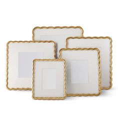 three white and gold frames with scalloped edges on a white background, set of four