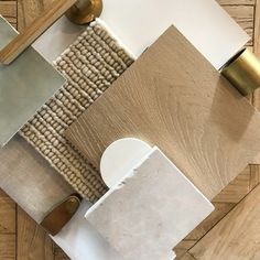 a wooden floor with different types of tile on top of it and gold hardware around the edges