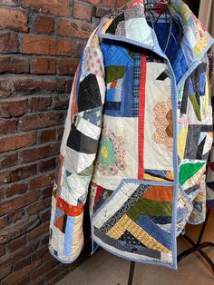 a colorful jacket hanging on a brick wall