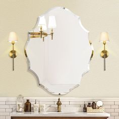 a bathroom vanity with a mirror and two lights on the wall next to each other