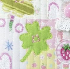 a close up of a patchwork fabric with various items on it