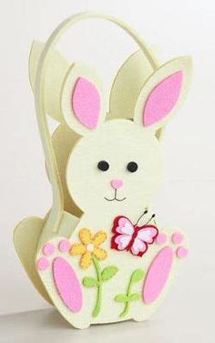 a white rabbit with pink ears holding a flower in its paws and a butterfly on it's back