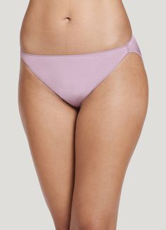 The Jockey® No Panty Line Promise Tactel String Bikini women's underwear provides a flattering look with comfortable coverage under any outfit. Tactel nylon and Lycra spandex offer a smooth, silky feel with plenty of stretch, while our unique leg binding helps eliminate panty lines. Slim sides provide less coverage for worry-free wear. | Jockey® No Panty Line Promise Tactel String Bikini in Soft Mauve Sleek Brief Swimwear, Sleek Stretch Swimwear With Smoothing Details, Sleek Smoothing Brief Swimwear, Sleek Seamless Swimwear Brief, Sleek Seamless Brief Bottoms, Solid Color Sleek Swimwear With Stretch, Sleek Stretch Brief Swimwear, Sleek Stretch Swimwear Brief, Modern Swimwear With Moderate Back Coverage