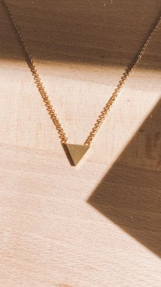 Get to the point and make a statement with this little gold triangle necklace. This statement necklace is a beautiful addition to any look. Triangle Necklace With Adjustable Chain For Gift, Minimalist Triangle Gold Jewelry, Minimalist Gold Triangle Jewelry, Elegant Triangle Necklace For Gifts, Elegant Gold Triangle Necklace, Elegant Triangle Everyday Jewelry, Gold Triangle Necklace For Gift, Dainty Gold Triangle Jewelry, Elegant Triangle Yellow Gold Necklace