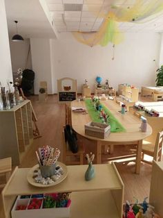 a room filled with lots of wooden furniture and toys on top of a hard wood floor