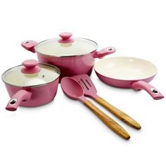 pink pots and pans with wooden utensils on a white background, set up for cooking