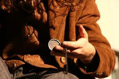 a person sitting down and holding a pocket watch