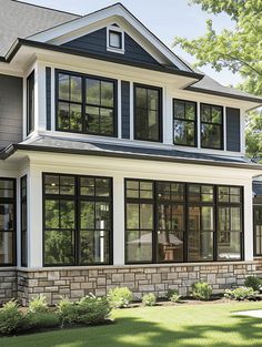 a large house with lots of windows in the front yard