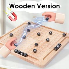 an image of a wooden board game with balls and magnets on it that says wooden version