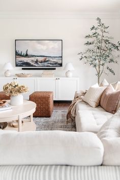 a living room filled with furniture and a painting on the wall