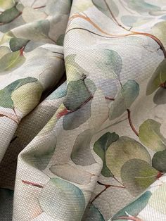 a close up view of a fabric with leaves on it