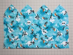 three pieces of blue fabric with snowmen on them