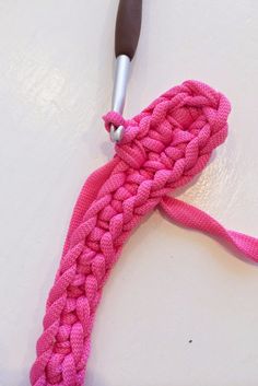 a crocheted pink rope with a metal hook