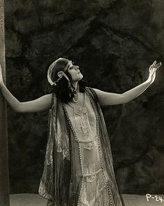 an old photo of a woman with her arms outstretched