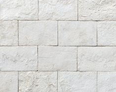 a white brick wall textured with cement blocks