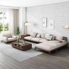 a living room with white brick walls and wood flooring, gray couches and coffee table