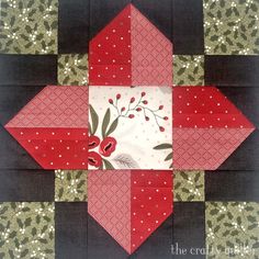 a red and black quilted block with flowers on it