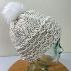 This warm winter hat was knit with a bulky off-white Acrylic yarn held together with a thin strand of beige. The snow white removable faux fur pom pom fastens to the hat with an elastic loop to a button on the inside. This unisex hat has a wonderfully textured brim. Constructed in a smoke-free, pet-free home. Please remove Pom Pom before washing. The hat may be machine washed and dried but to preserve its life, I recommend hand washing in a no-rinse product like Soak or Eucalan and dry flat. Follow me on Instagram: @margaret_giralte, and on Facebook: Giralté Gems and Beads. See my knit and crochet patterns at Margaret Giralté Designs on Ravelry .com Warm Winter Hats, Faux Fur Pom Pom, Fur Pom Pom, White Acrylic, White Acrylics, Winter Hat, White Beige, Acrylic Yarn, Hand Washing