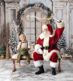 a little boy sitting on a bench next to santa clause