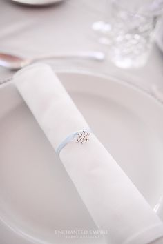 a napkin with a ring on it sitting on a plate