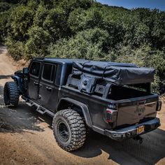 an off road vehicle with a tarp on it's back