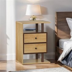 a wooden night stand with two drawers and a lamp on the nightstand next to it