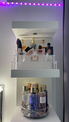 the shelves are filled with beauty products and perfumes in glass containers on top of each other