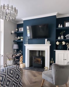 a living room with blue walls and white trimmings is shown in this image