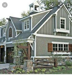 a gray house with white trim and windows