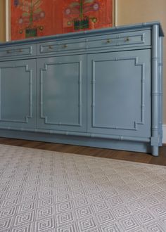 a large blue cabinet sitting in the middle of a living room next to a rug